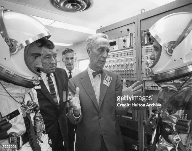 American artist Norman Rockwell talks to astronauts John W Young and Virgil I. Grissom , the pilots selected to fly the first manned Gemini orbital...
