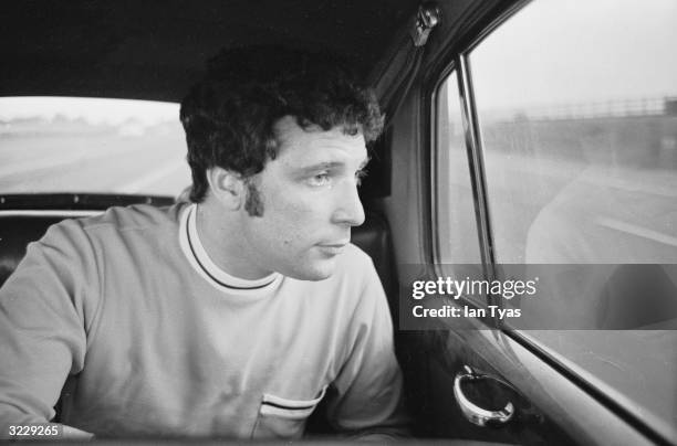 Welsh musical sensation and sex symbol, Tom Jones, stares thoughtfully out the back of a car whilst travelling to a concert in Blackpool.