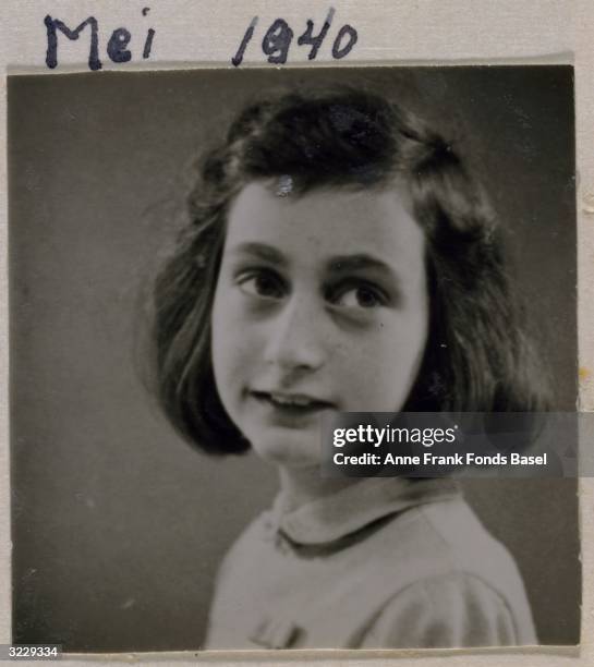 Passport photo of Anne Frank looking to her left, taken from her photo album, Amsterdam, Holland.
