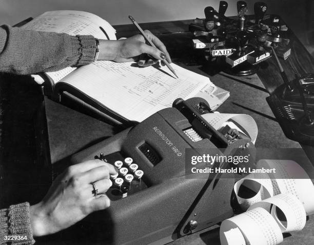 Woman Using A Adding Machine Adding Machine Receipt Photos and Premium High Res Pictures - Getty Images