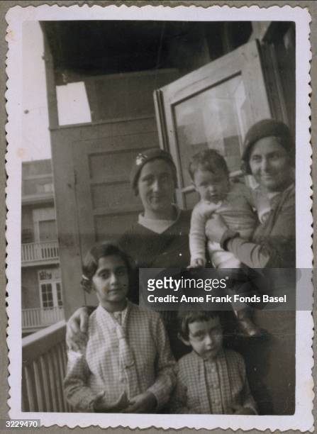 Anne Frank , , her sister, Margot Frank , their mother, Edith Frank-Hollander, and a woman holding a child standing on a balcony. From Anne Frank's...