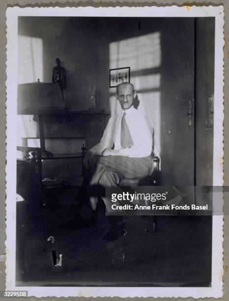 Portrait of Otto Frank, Anne Frank's father, sitting in a chair in the living room of the Frank's flat in Merwedeplein, Amsterdam, the Netherlands....