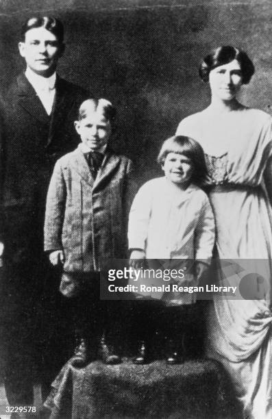 Family studio portrait of Jack and Nelle Reagan posing with their sons Neil and future U.S. President Ronald Reagan, Galesburg, Illinois.