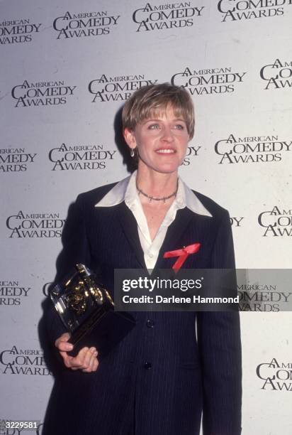 American actor Ellen DeGeneres poses with her trophy at the American Comedy Awards, Los Angeles, California. DeGeneres won Funniest Female Performer...