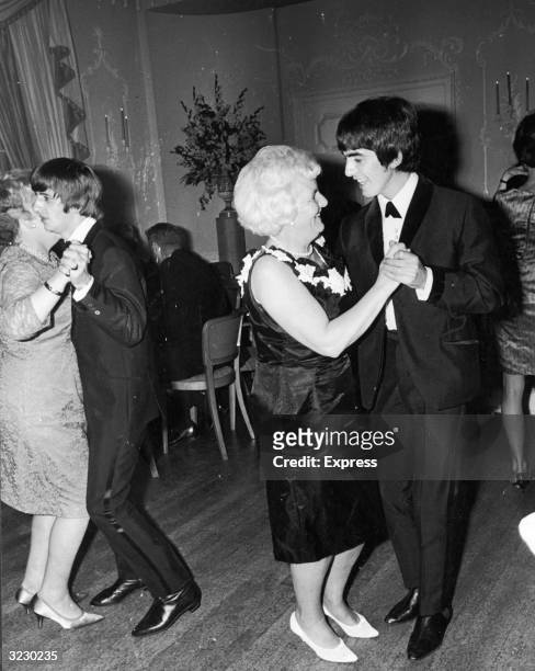 British musicians George Harrison and Ringo Starr, members of the rock group The Beatles, dance with their mothers at the premiere party for their...