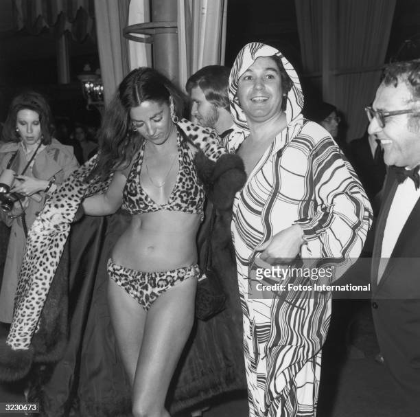 American actor Edy Williams opens her leopard fur coat to reveal a leopard fur bikini at the Academy Awards, Dorothy Chandler Pavilion, L A County...