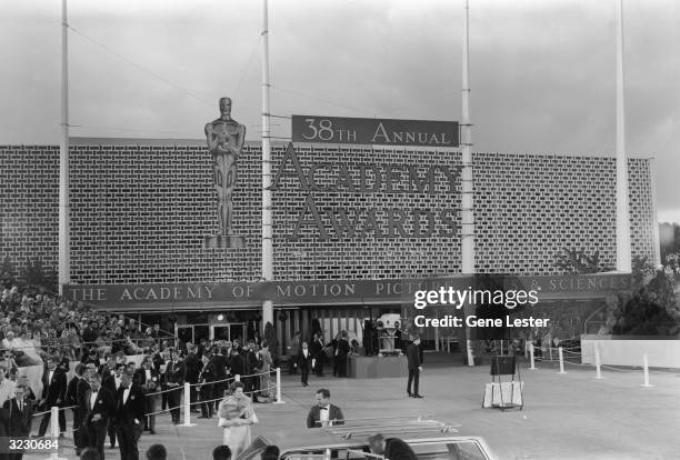 Exterior view of the Santa Monica Civic Auditorium, which bears a sign for the 38th Annual Academy Awards, sponsored by the Academy of Motion Picture...