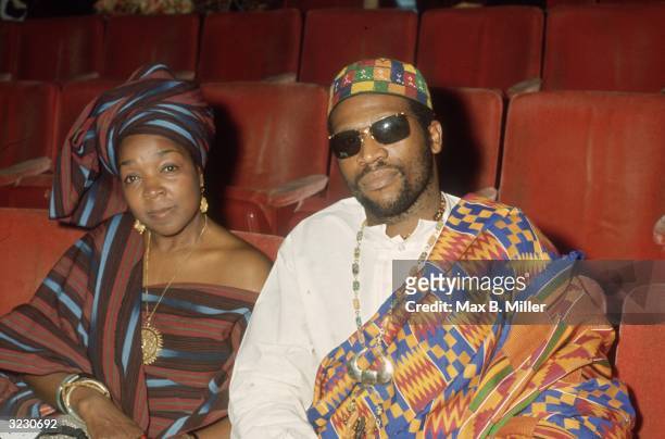 American folk and blues musician Taj Majal sits in his seat beside an unidentified woman at the Academy Awards, Los Angeles, California. They wear...