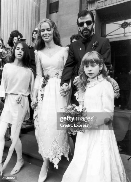 Left to right, Francesca Gregorini, American actress Barbara Bach, English musician Ringo Starr, and Lee Starkey walk together hand in hand on Starr...