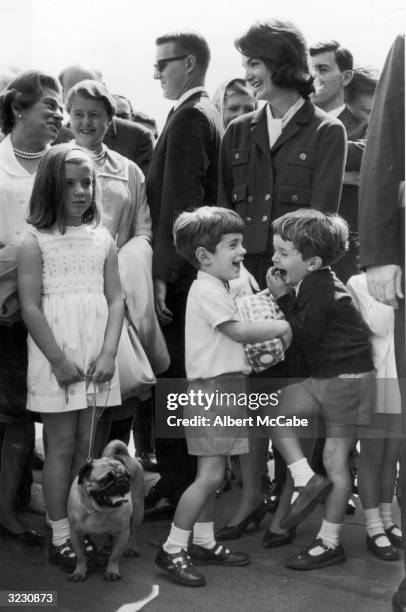 Jacqueline Bouvier Kennedy stands with her daughter, Caroline, her son, John F. Kennedy Jr. , and her nephew, Anthony Radziwill, outside Buckingham...