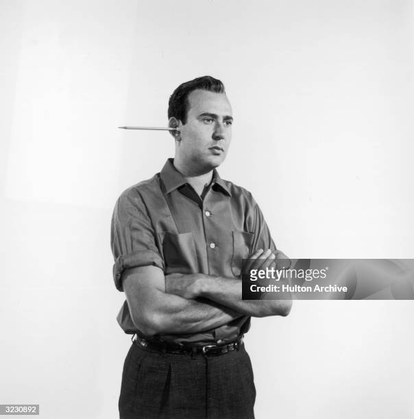 American actor and comedy writer Carl Reiner with a pencil protruding from one ear.