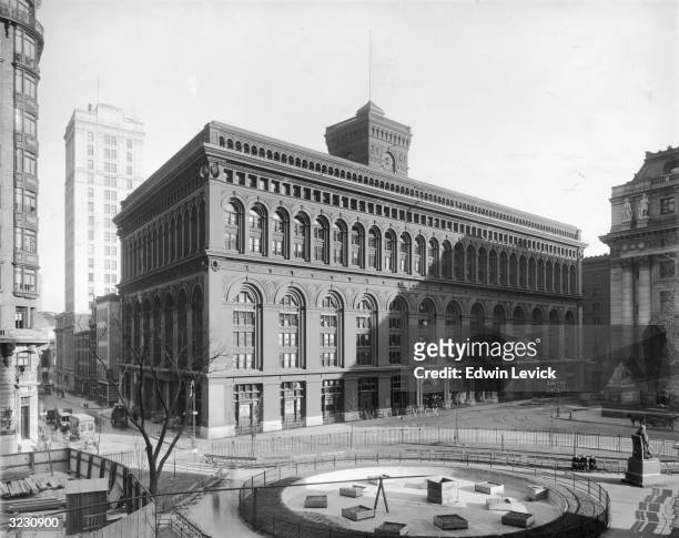 The Produce Exchange building at Bowling Green and Beaver Street during the park's construction, with the Custom House to the right, Lower Manhattan,...