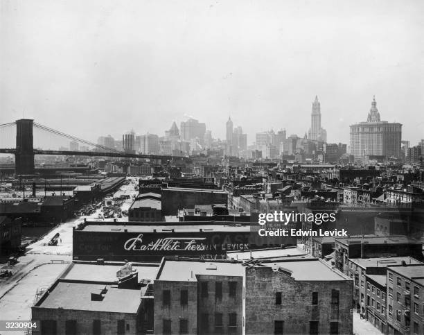 View of the buildings at South Street Seaport and the Brooklyn Bridge, with the office buildings of Lower Manhattan in the background..