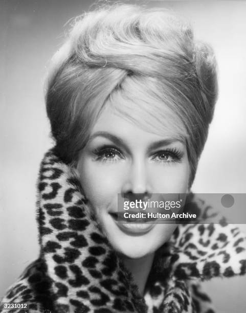 American actress Barbara Eden wearing a leopard-print fur jacket with the collar turned up. Eden starred in the television series, 'I Dream of...