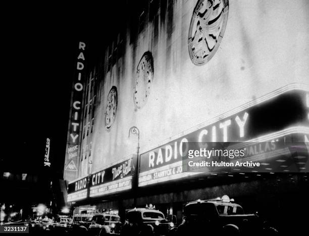The exterior of Radio City Music Hall with a neon marquee advertising director King Vidor's film, 'Stella Dallas,' starring Barbara Stanwyck, Sixth...
