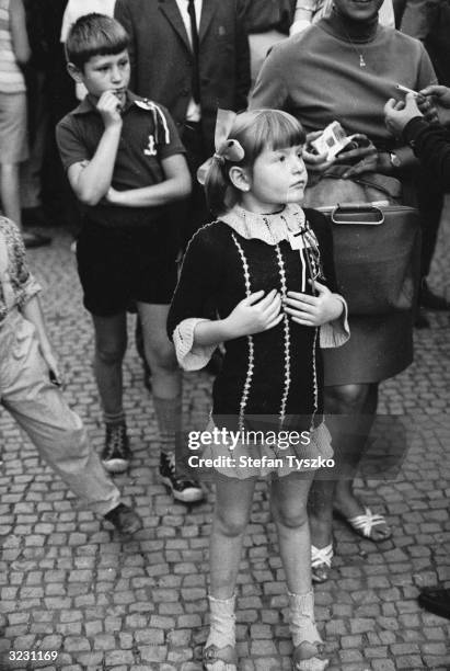 Young Czechoslovakian girl watches events unfold in St Wenceslas Square, Prague, during the Soviet invasion.