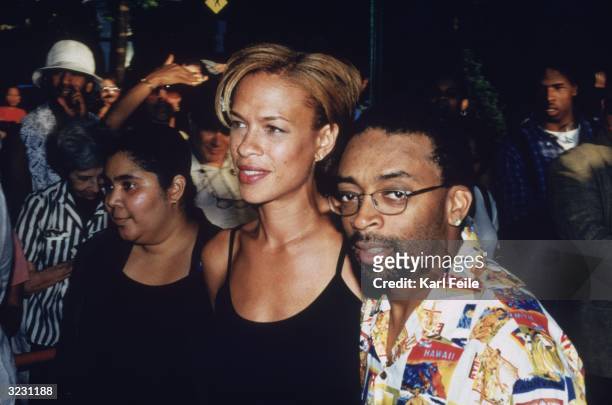 American director Spike Lee, wearing a Hawaiian print shirt, and his wife, Tanya, walking past a crowd at the New York premiere of the HBO television...