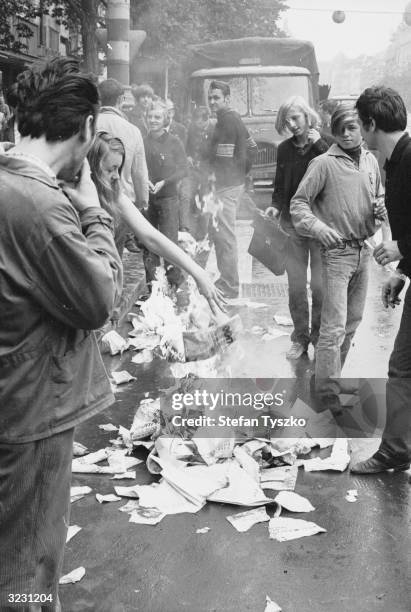 Czechs burn propagandist literature dropped by circling Soviet helicopters during the invasion of Czechoslovakia.