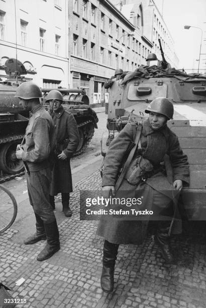 Soviet troops on the streets of Prague man a blockade of tanks and armoured personnel carriers.