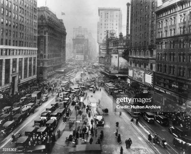 High-angle view of Times Square, looking uptown from 43rd Street, crowded with automobile, streetcar and pedestrian traffic, New York City.