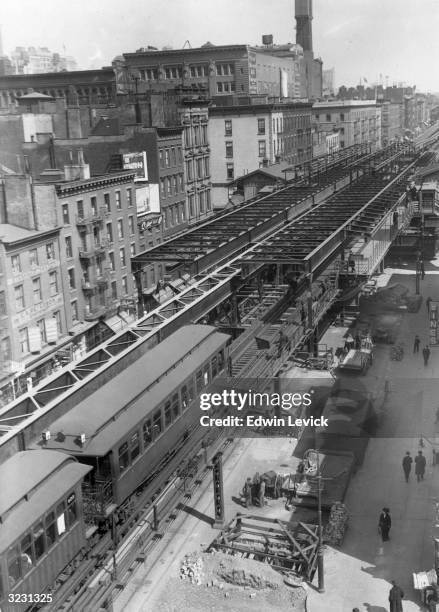 High-angle view of the 23rd Street elevated train station on Third Avenue, with road construction underneath and people walking on the sidewalk, New...
