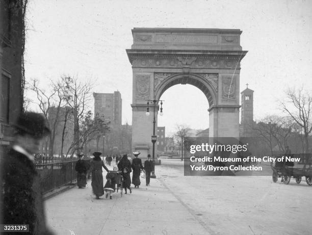 View of the Washington Arch, looking south from Fifth Avenue in Washington Square Park, New York City. The Arch was designed by Stanford White. The...