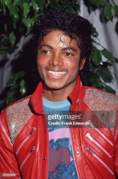 Portrait of American pop star Michael Jackson wearing a red leather jacket at the opening of the stage musical, 'Dream Girls,' Los Angeles,...