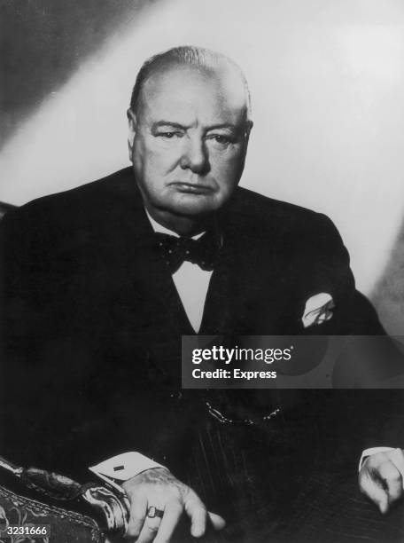 Studio portrait of British prime minister Winston Churchill sitting in an armchair.