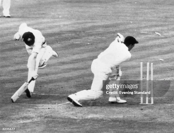 Australian batsman Bill Lawry is run out by England wicketkeeper John Murray from a throw by Geoff Pullar, during the 4th Test Match at Manchester.