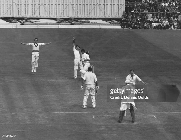 Richie Benaud strikes and England's Ted Dexter is caught for 76 during the last day of the 4th Test at Old Trafford. England's second innings ended...