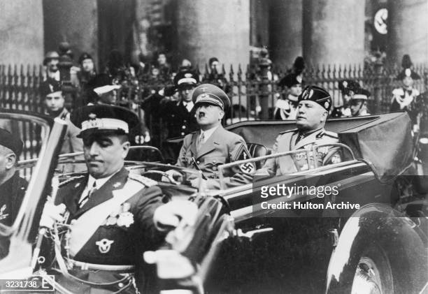 German Fuhrer Adolf Hitler rides in an open car with Italian dictator Benito Mussolini during a visit to Italy.