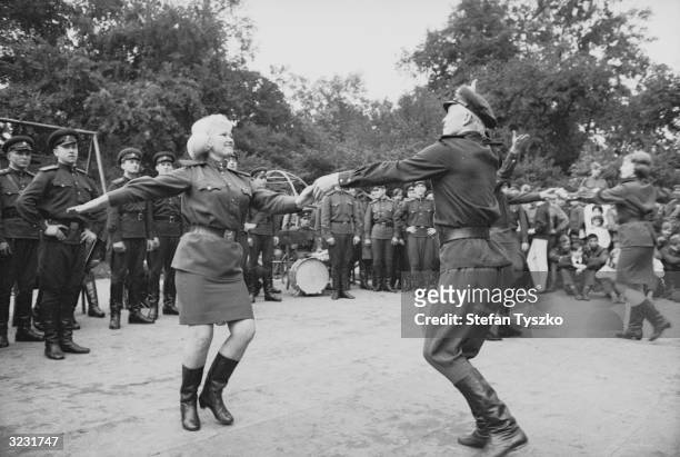 The Red Army Ensemble dancing to entertain Soviet troops at their encampment in a Prague park during their country's invasion of Czechoslovakia.