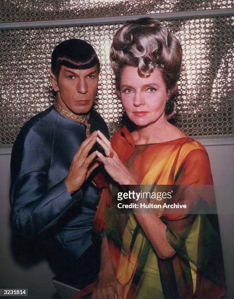 American actors Leonard Nimoy and Jane Wyatt pose in costume in a promotional portrait for the television series, 'Star Trek,' for an episode...