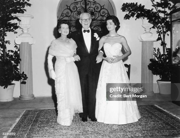 Full-length portrait of Rose Kennedy and her husband, American financier Joseph Kennedy , posing with their daughter-in-law, Jacqueline Kennedy , at...