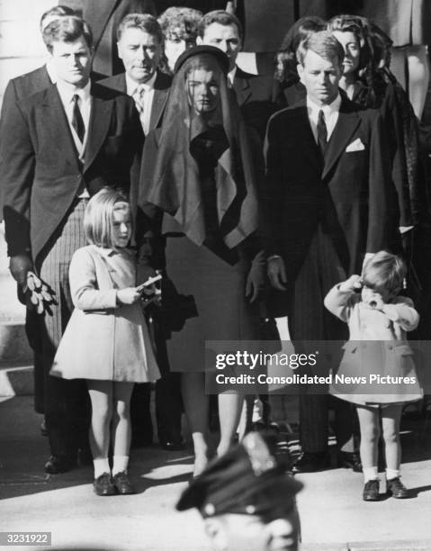 Jacqueline Kennedy stands with her children, Caroline and John Jr , and her brothers-in-law, Senator Edward 'Ted' Kennedy and US Attorney General...