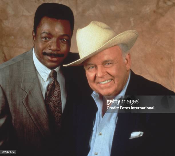 Promotional studio portrait of American actors Carl Weathers and Carroll O'Connor , from the television series, 'In the Heat of the Night'. O'Connor...