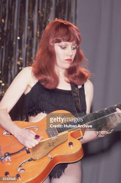 Guitarist Kirsty 'Poison Ivy Rorschach' Wallace of the American punk rock band The Cramps performs on stage with a hollow-body electric guitar. She...