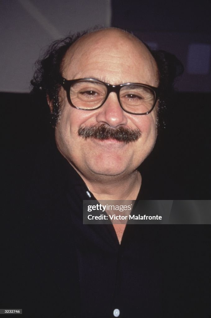 Danny De Headshot portrait of American actor Danny DeVito wearing eyeglasses ...