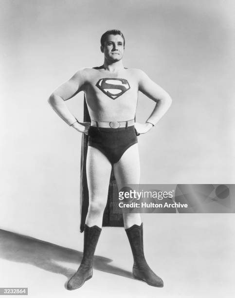 Full-length studio portrait of American actor George Reeves in costume as the Man of Steel from the TV show 'Superman'.