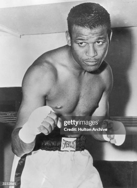 Portrait of American boxer Sugar Ray Robinson , welterweight champion from 1946 - 1951, posing in fight stance and wearing boxing shorts.