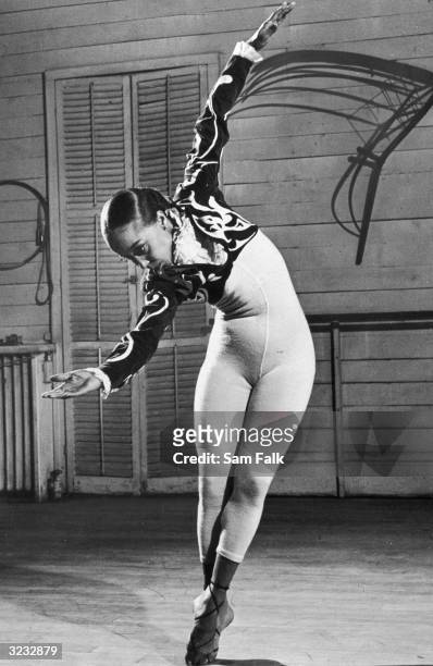 Full-length image of Janet Collins, former Metropolitan Opera ballet soloist, dancing at rehearsal while wearing a bolero top and unitard.