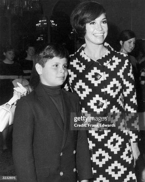 American actor Mary Tyler Moore puts her arm around her son, Richard Meeker Jr , at a Teach Foundation benefit. Moore is wearing a dress with...