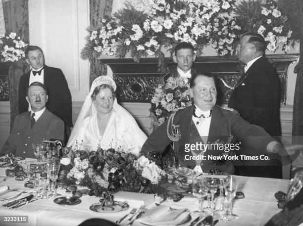 Prussian premier and Reich Air Minister Hermann Goering and his bride, German actor Emmy Sonnemann , are joined by German Fuhrer Adolf Hitler at a...