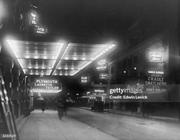 View of marquees for the Plymouth Laurette Taylor, the Music Box, the Imperial, and the Klaw Theaters along 45th Street, looking west from Broadway...