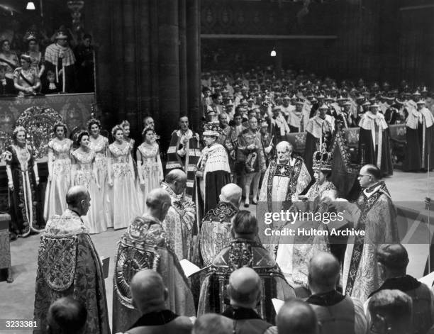 Queen Elizabeth II holds the Rod with Dove in her left hand and the Sceptre with Cross in her right hand, shortly after being crowned in Westminster...