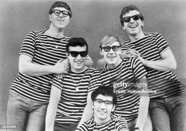 Portrait of the British rock and roll band, 'Freddie and the Dreamers,' all wearing glasses and matching striped T-shirts, 1960s. The members are;...