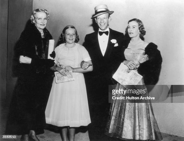 American dancer, singer, actor Fred Astaire poses with his mother, Ann, his daughter, Ava, and his first wife, Phyllis, at the premiere of the film,...