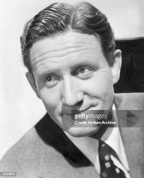 Closeup portrait of American actor Spencer Tracy smiling.