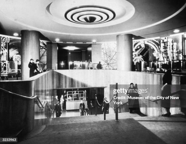 People stand at the top of the Grand Staircase to the Museum at Radio City Music Hall in New York City.