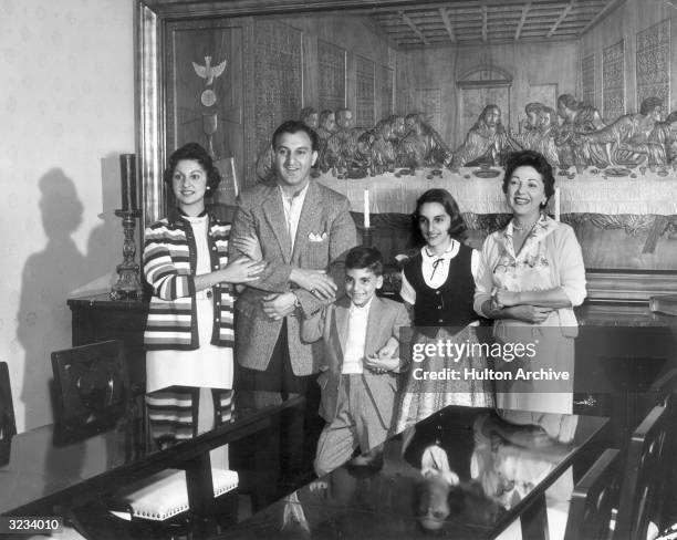 American actor Danny Thomas poses with his family in front of a metal replica of Leonardo da Vinci's 'The Last Supper'. L-R: daughter Marlo, son...